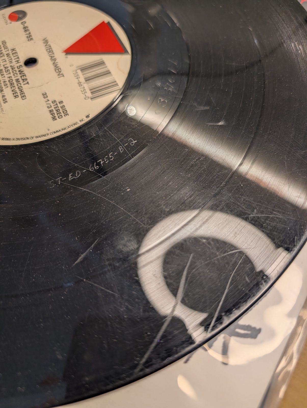 Worn record — Keith Sweat 12 inch, deep scratches and gouges, discarded